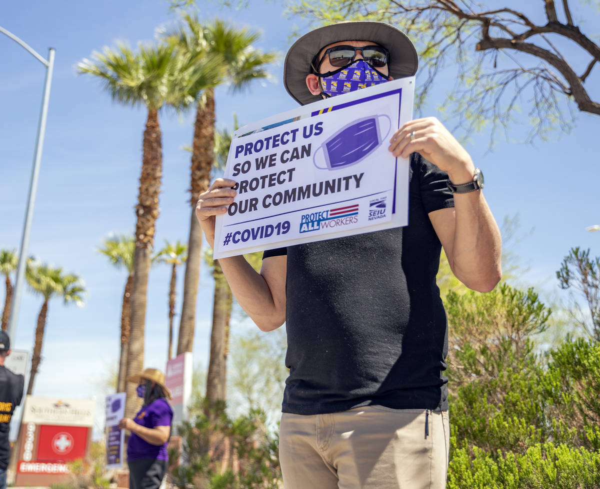 Jason, a Local SEIU 1107 member, holds a sign in protest of unsafe working conditions during th ...