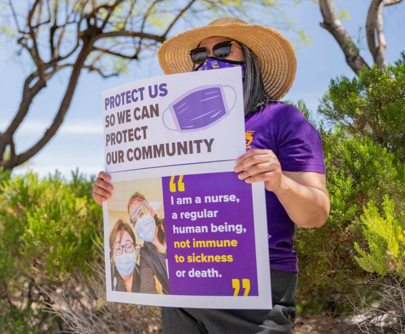 Grace Vergara-Mactal, executive director of Local SEIU 1107, holds a sign in protest of unsafe ...