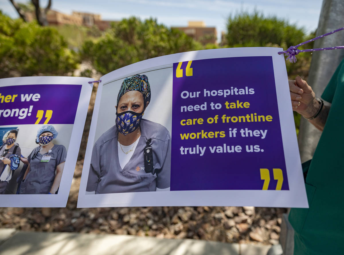 Local SEIU 1107 member holds a sign in protest of unsafe working conditions during the COVID-19 ...