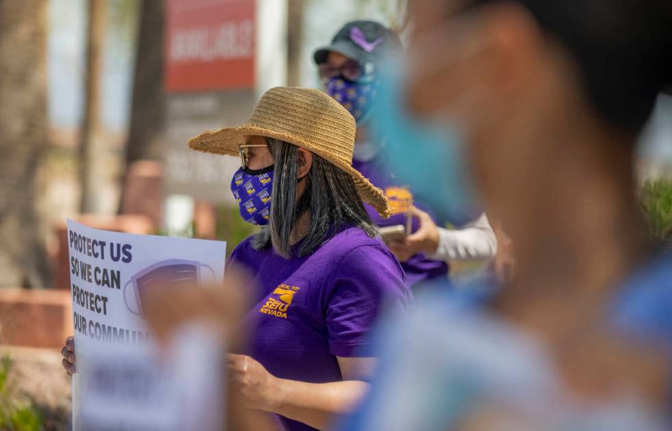 Grace Vergara-Mactal, executive director of Local SEIU 1107, holds a sign in protest of unsafe ...