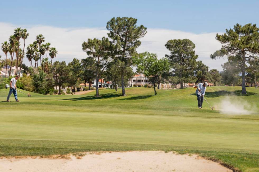 Groundskeepers prepare for the opening of the Spanish Trail Country Club and Golf Course in Las ...