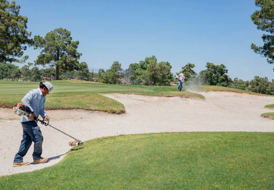 Groundskeepers prepare for the opening of the Spanish Trail Country Club and Golf Course in Las ...