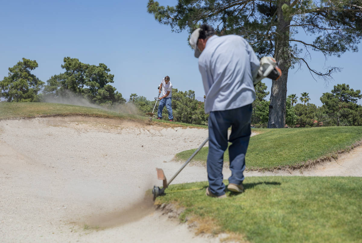 Groundskeepers prepare for the opening of the Spanish Trail Country Club and Golf Course in Las ...