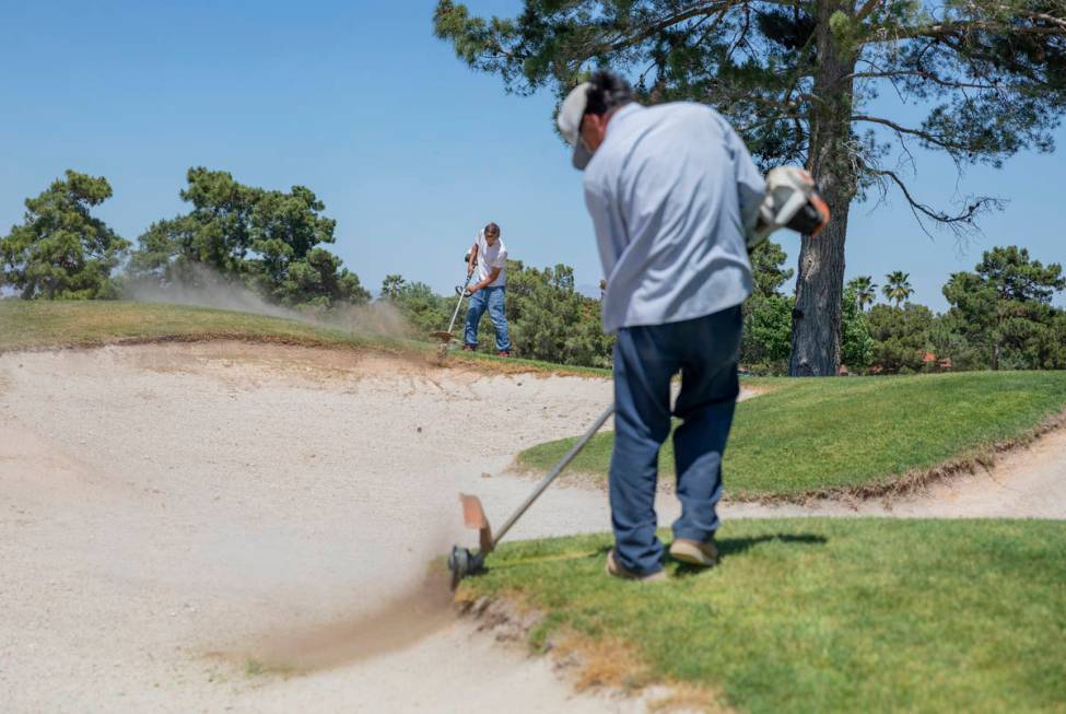 Groundskeepers prepare for the opening of the Spanish Trail Country Club and Golf Course in Las ...