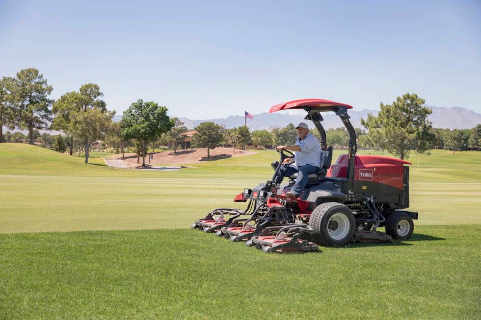 Groundskeeping is done to prepare for the opening of the Spanish Trail Country Club and Golf Co ...