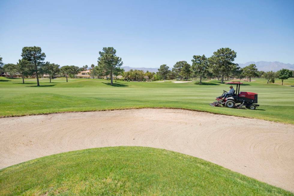 Groundskeeping is done to prepare for the opening of the Spanish Trail Country Club and Golf Co ...