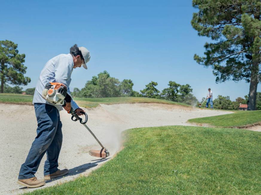 Groundskeepers prepare for the opening of the Spanish Trail Country Club and Golf Course in Las ...