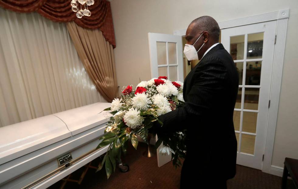 Baseball Hall of Famer Andre Dawson puts an arrangement of flowers on a casket at Paradise Memo ...