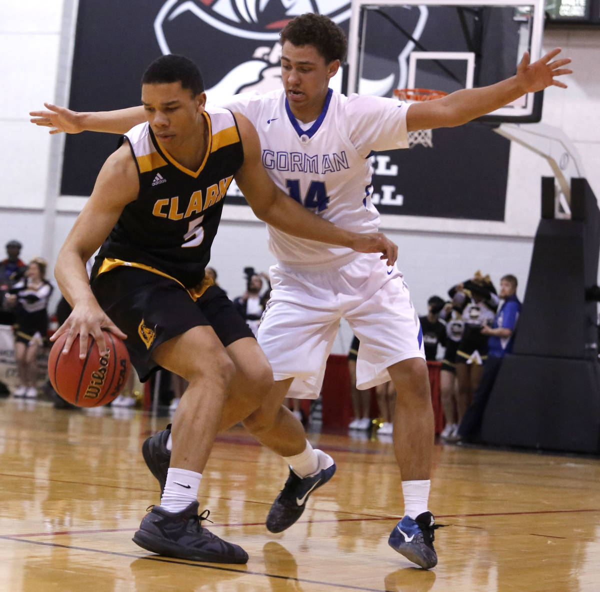 Clark's Deshawn Wilson (5) dribbles against Bishop Gorman's Saxton Howard (14) during the secon ...