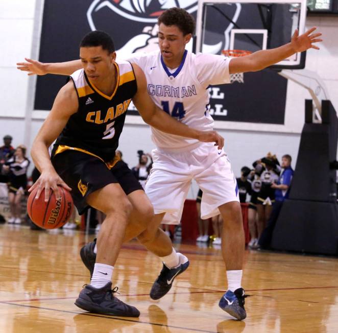 Clark's Deshawn Wilson (5) dribbles against Bishop Gorman's Saxton Howard (14) during the secon ...