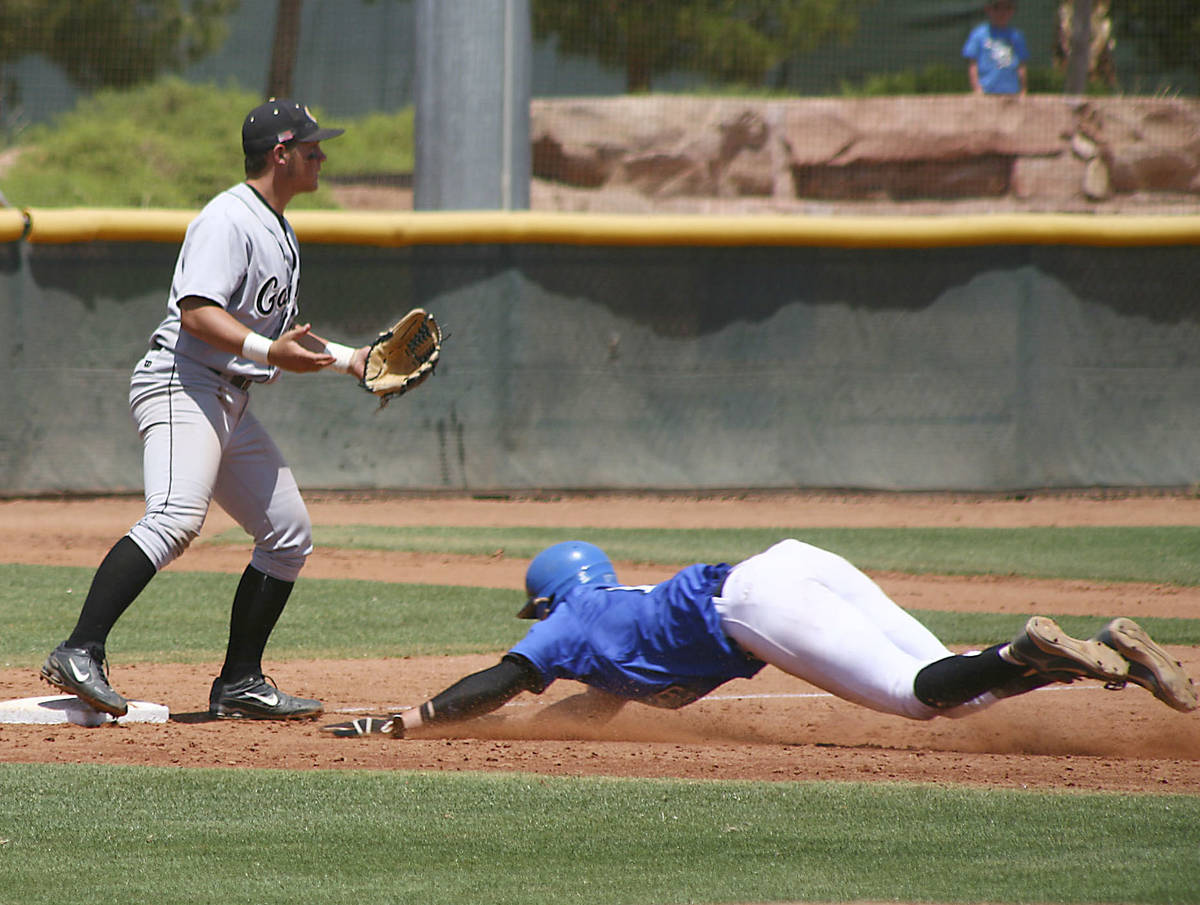 BIshop Gorman Pitcher Jeff Malm slides head first into 3rd base during the state championship g ...