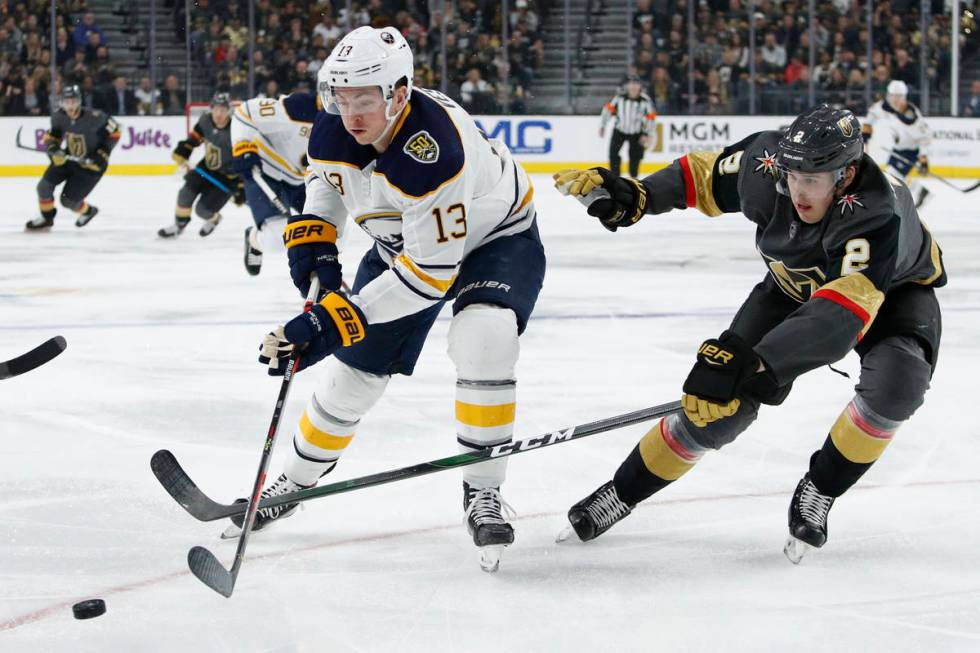 Buffalo Sabres left wing Jimmy Vesey (13) skates around Vegas Golden Knights' Zach Whitecloud d ...