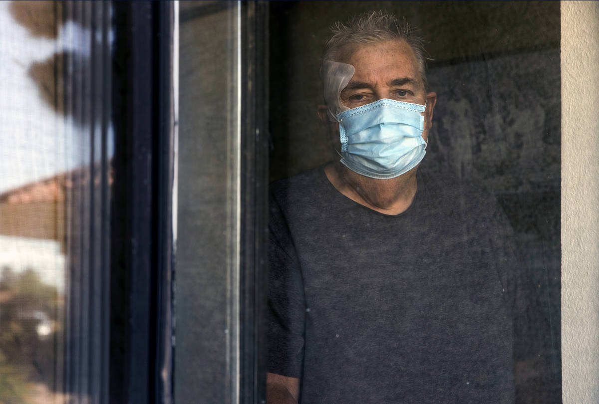 Richard Haacke, from behind the window of his room, is a patient at the College Park Rehabilita ...