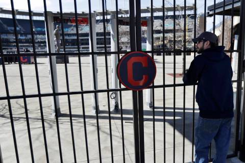 In this March 26, 2020, file photo, Jason Hackedorn looks into Progressive Field, home of the C ...