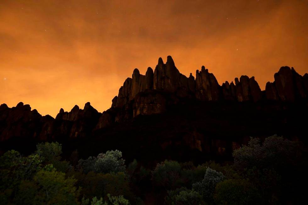 The Montserrat mountain range outside of Barcelona stands as the sun sets during the lockdown t ...