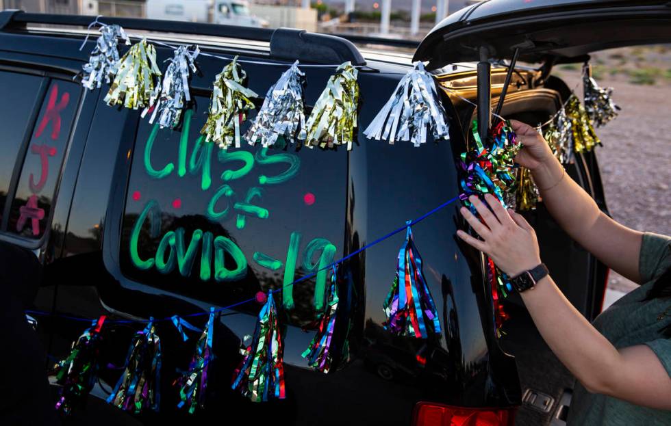 Vanessa Galvez sets up decorations before the start of the Desert Oasis High School senior prom ...