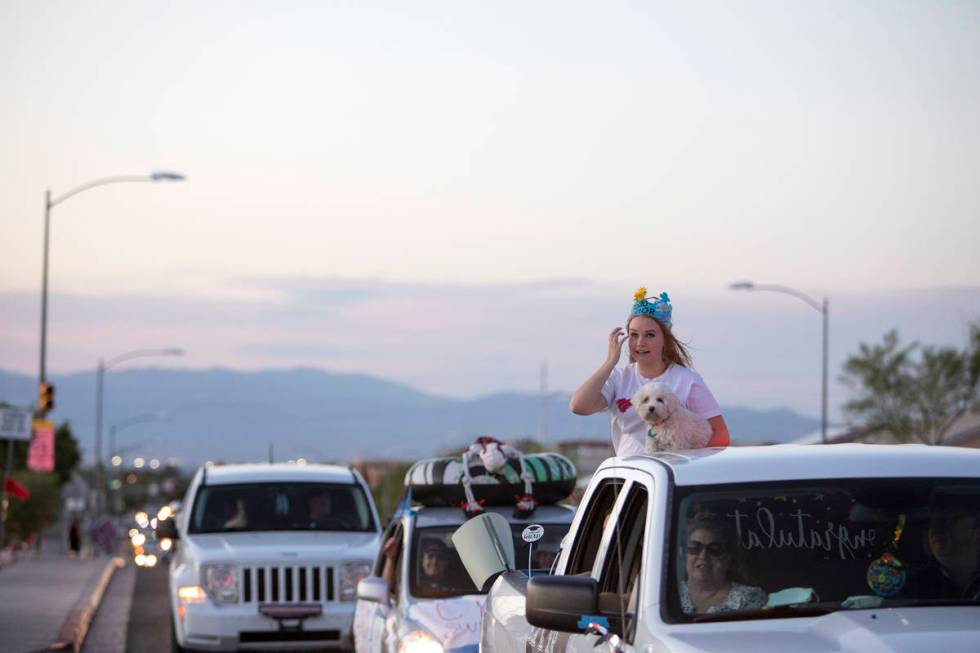 One senior wipes her tears during a drive-through parade to honor the class of 2020 at Coronado ...