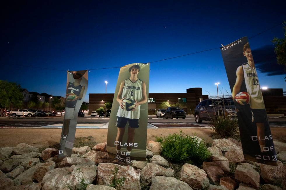 Photos of members of Coronado's basketball team seniors hang beside a drive-through parade for ...