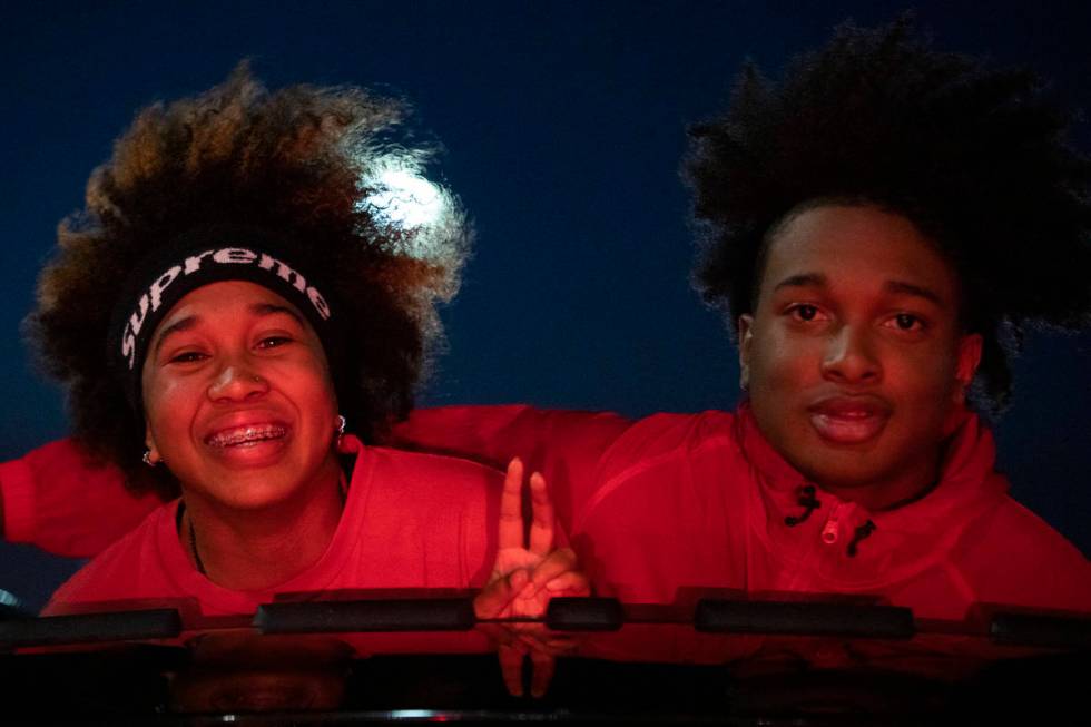 Senior Sade Williams, a basketball player, and her brother Tahj Williams, drive through the sen ...