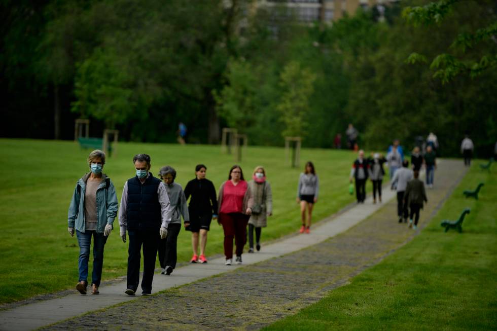 People wearing face masks to protect against coronavirus exercise along Vuelta del Castillo par ...