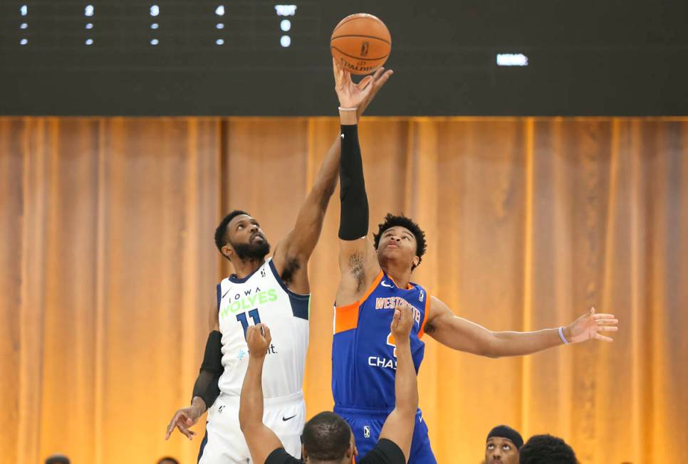 Iowa Wolves center Hakim Warrick (11) and Westchester Knicks center Isaiah Hicks (4) tip off to ...