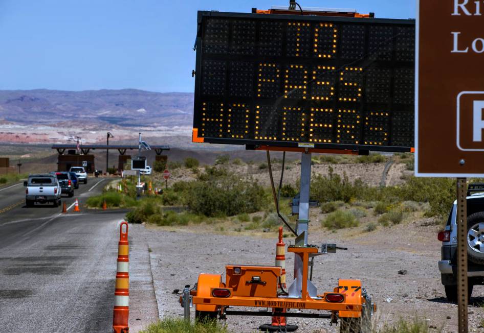 Cars approach an entry point for the Lake Mead National Recreation Area which is now open to an ...