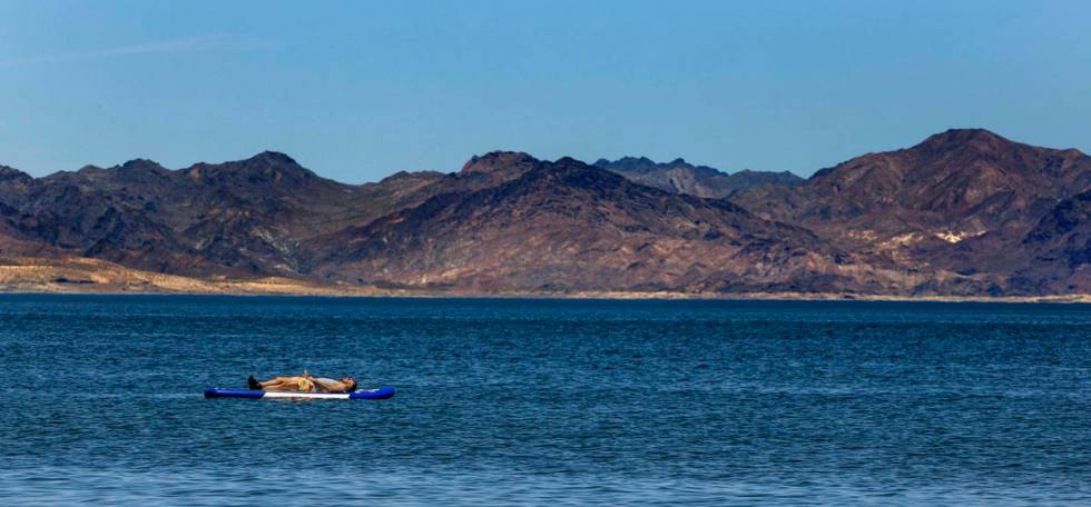 A paddle boarder floats in the water at the Boulder Beach in the Lake Mead National Recreation ...
