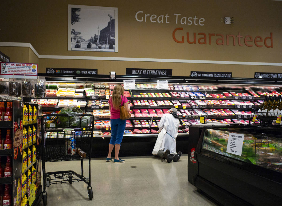 A worker stocks shelves in the meat section at Albertson's in Las Vegas on Saturday, May 2, 202 ...