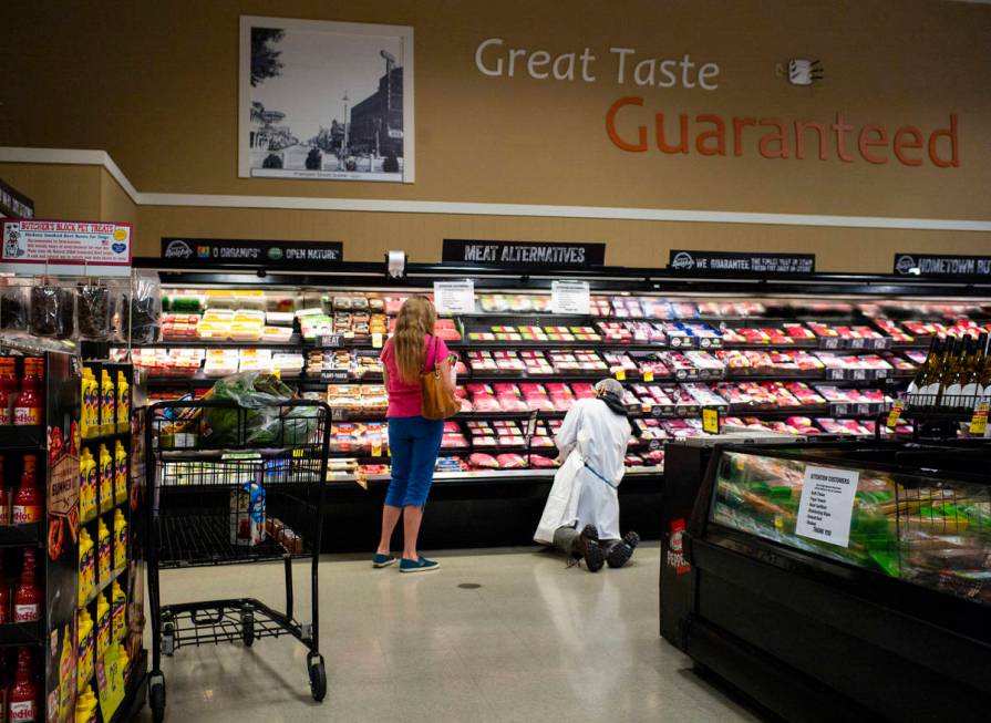 A worker stocks shelves in the meat section at Albertson's in Las Vegas on Saturday, May 2, 202 ...