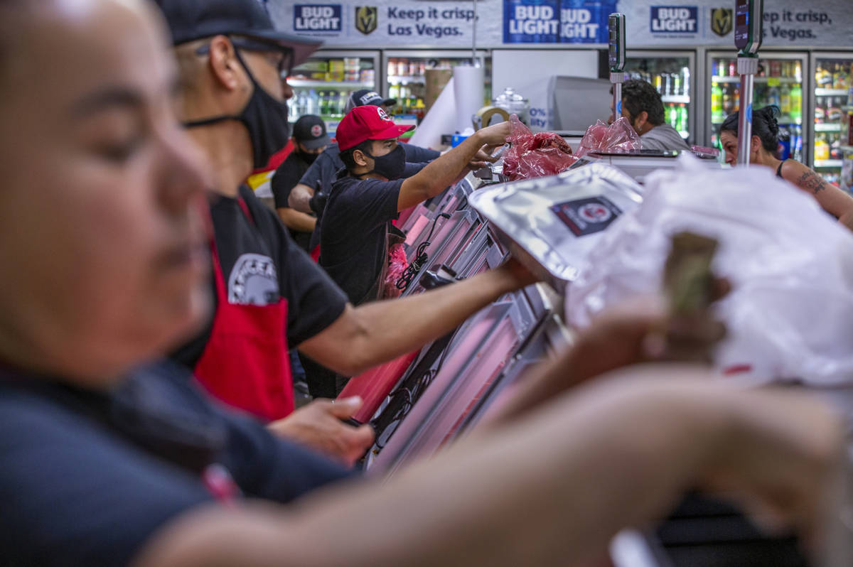 The counter is busy at the Los Primos Meat Market with purchases on the rise recently on Sunday ...