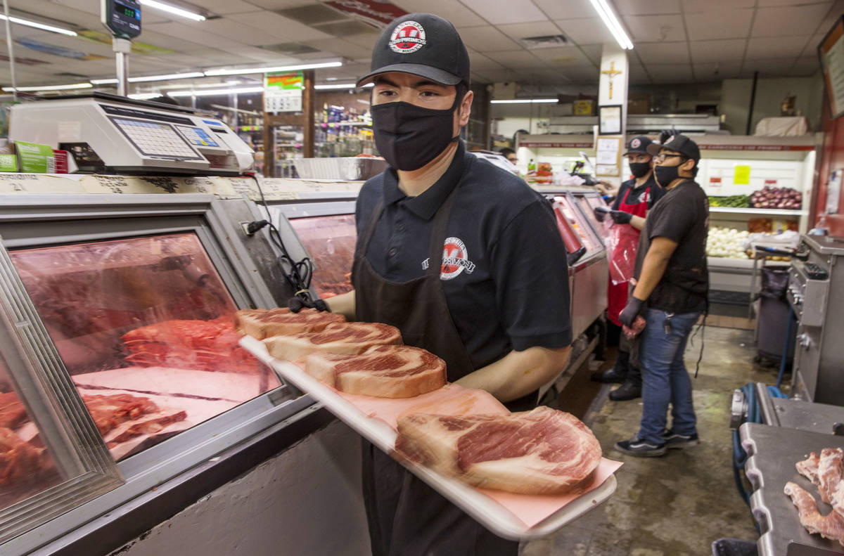 Joey Nuno stocks up a beef cooler at the Los Primos Meat Market on Sunday, May 3, 2020 in Las V ...