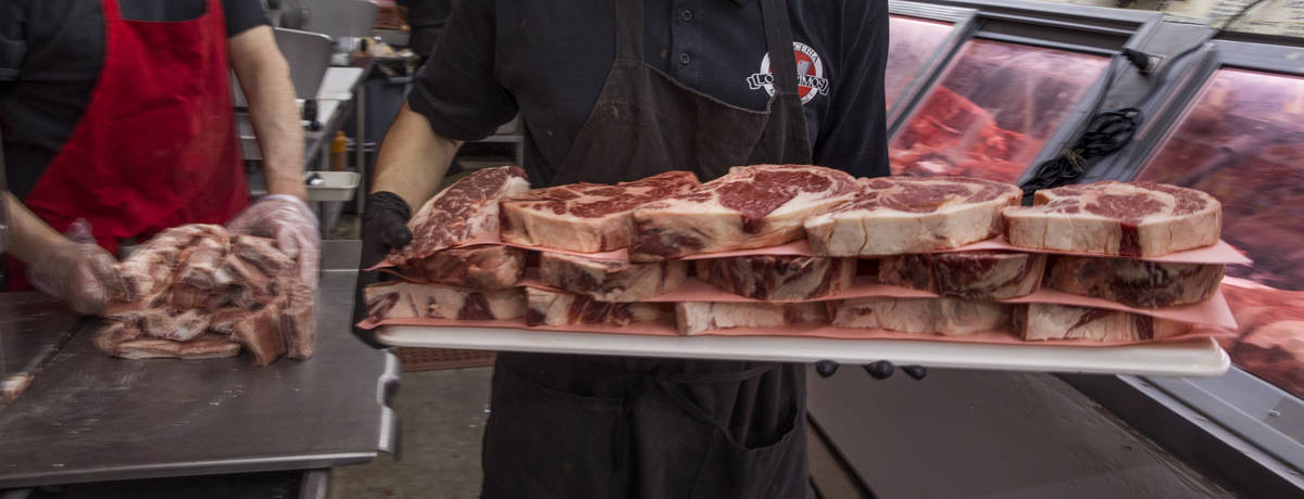 Joey Nuno stocks up a beef cooler at the Los Primos Meat Market on Sunday, May 3, 2020 in Las V ...