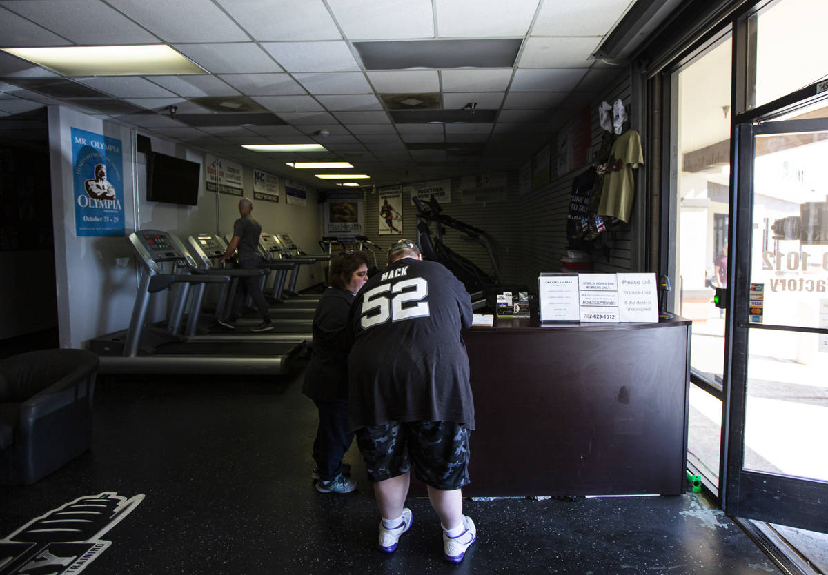 Paul Minor signs in at The Lift Factory with his mother, Jaunice Minor, in Las Vegas on Thursda ...