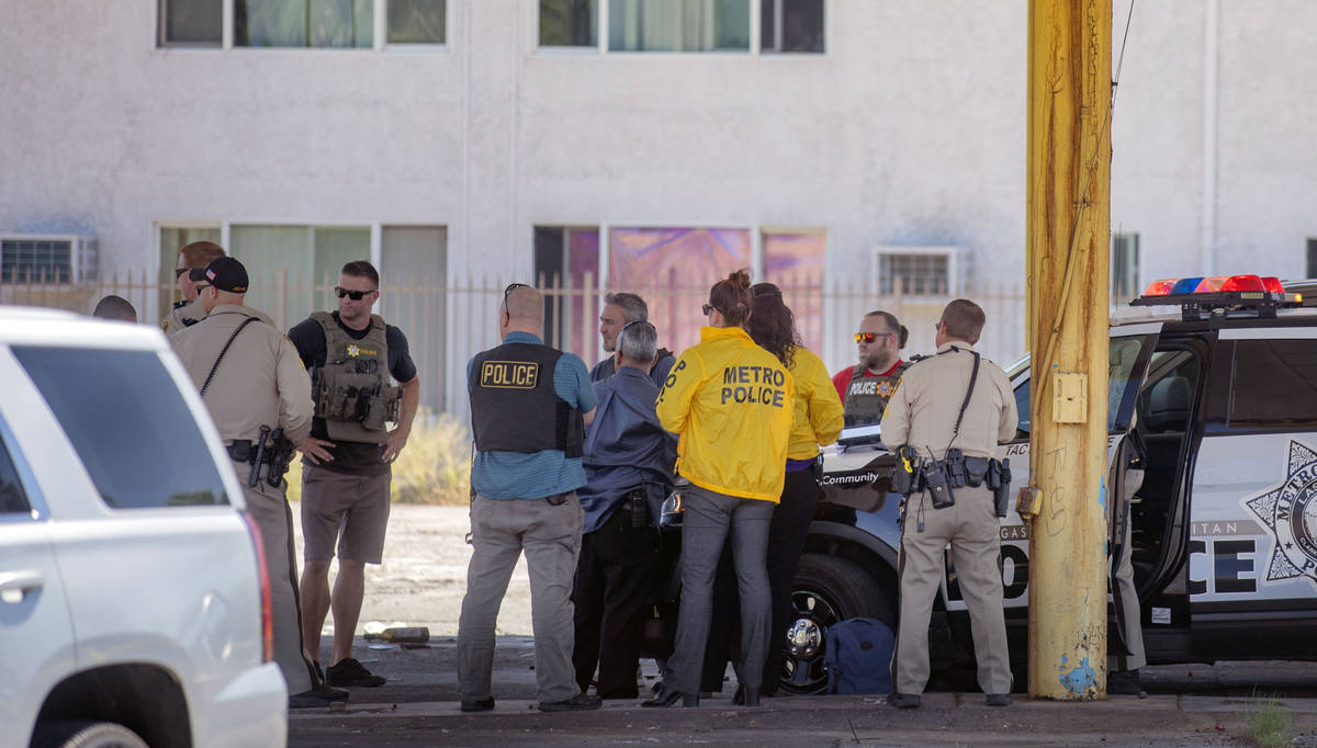 Las Vegas police investigate a downtown shooting in the 1900 block of Fremont Street in Las Veg ...