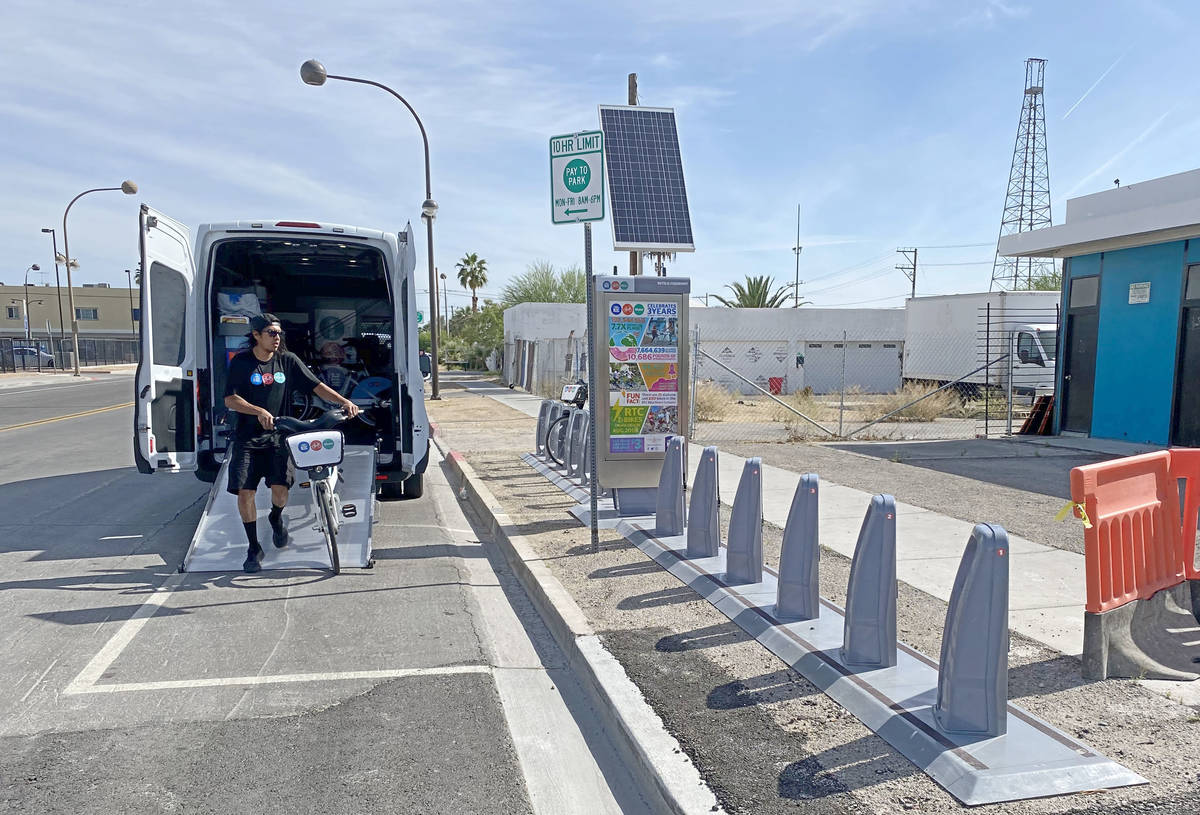 A Regional Transportation Commission worker reloads an empty RTC Bike Share station on the corn ...