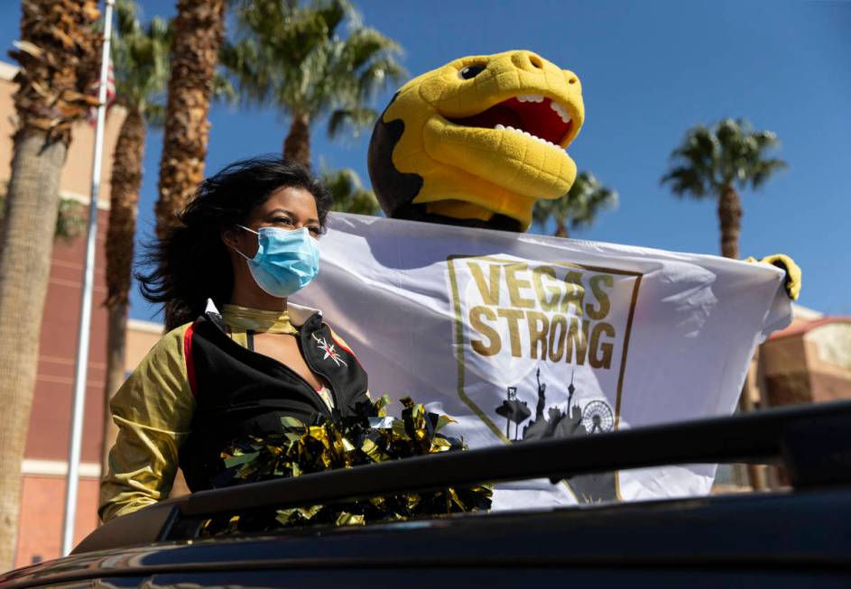 Golden Knights mascot Chance, top/right, and a member of the Golden Aces cheer for Mountain Vie ...