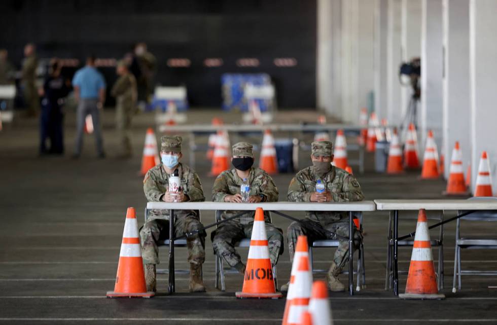 National Guard soldiers, from left, Pvt. Ezekiel Pinedo, Sgt. Joshua Tuando and Pvt. Edwin Gall ...