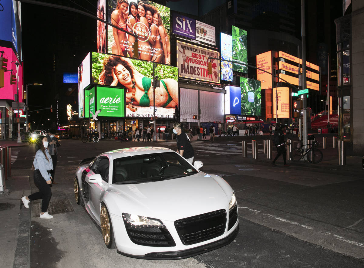 In this Saturday, May 2, 2020 photo, Claudia Luong, left, and Danny Lin hop into his 2008 Audi ...