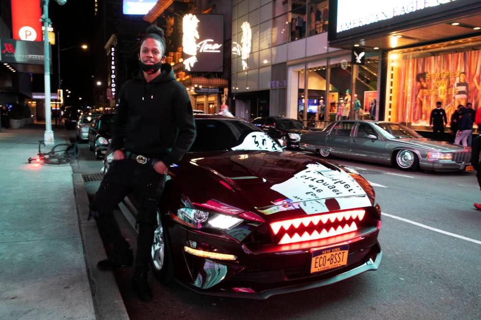 In this Saturday, May 2, 2020 photo, Andre Godfrey poses with his 2018 Ford Mustang EcoBoost - ...