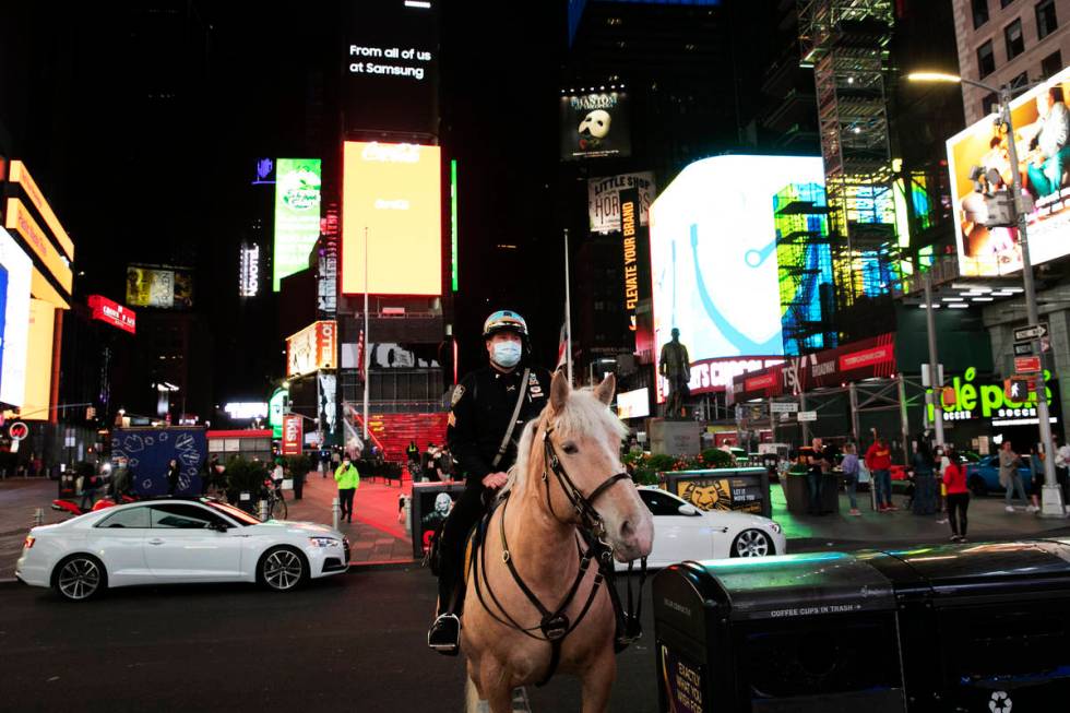 In this Saturday, May 2, 2020 photo, a New York City mounted police officer is posted in Times ...