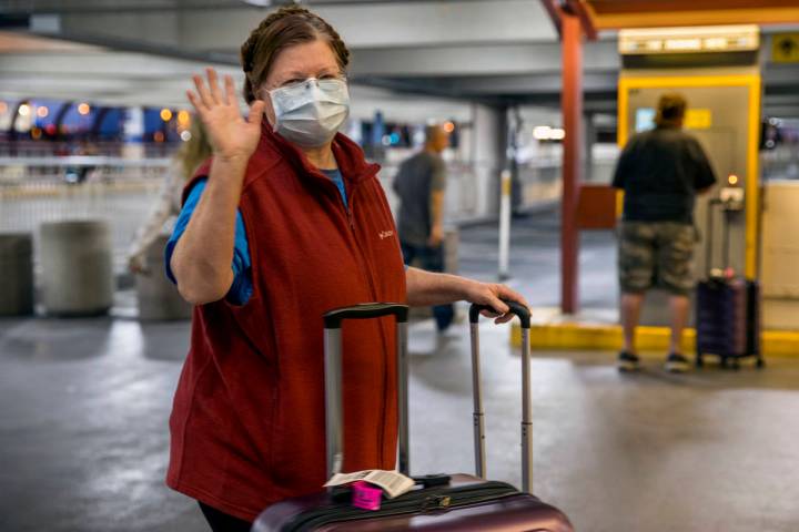 Susan Yowell waves goodbye as husband Jack pays for parking after arriving at McCarran Internat ...