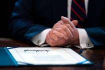 FILE - In this March 27, 2020, file photo President Donald Trump finishes signing the coronavir ...