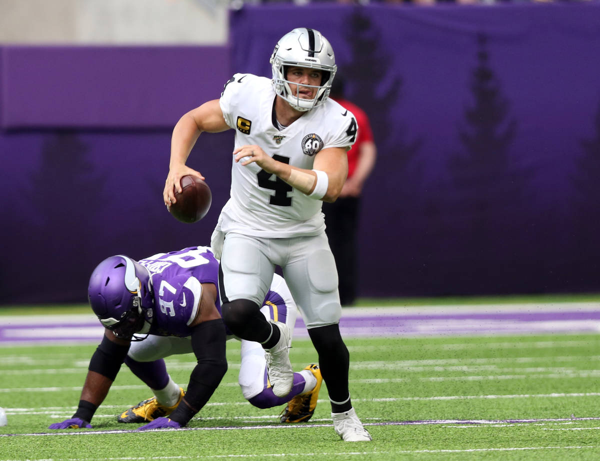 Oakland Raiders quarterback Derek Carr (4) rushes with the football after Minnesota Vikings def ...