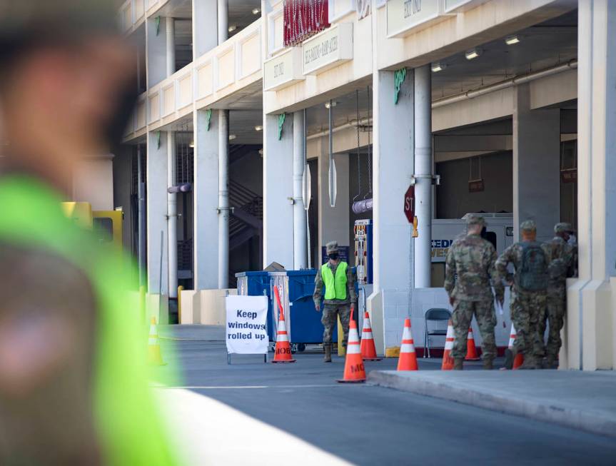 The Nevada National Guard waits for patients at the COVID-19 drive-through testing at the parki ...