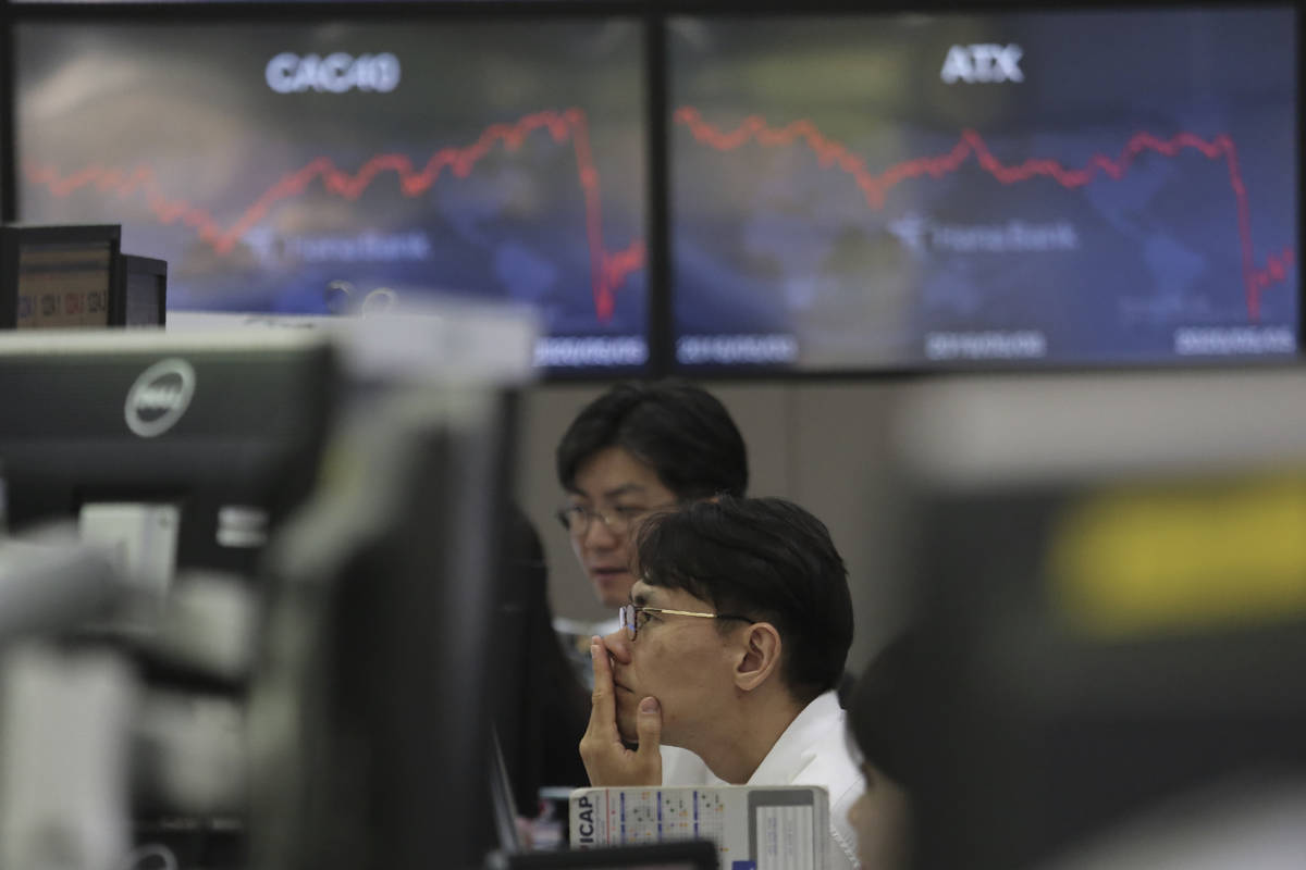 A currency trader watches monitors at the foreign exchange dealing room of the KEB Hana Bank he ...