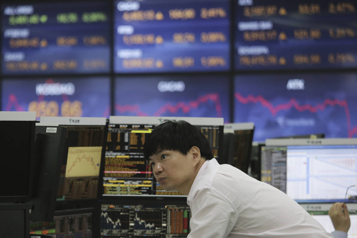 A currency trader watches monitors at the foreign exchange dealing room of the KEB Hana Bank he ...