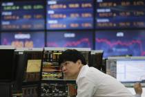 A currency trader watches monitors at the foreign exchange dealing room of the KEB Hana Bank he ...