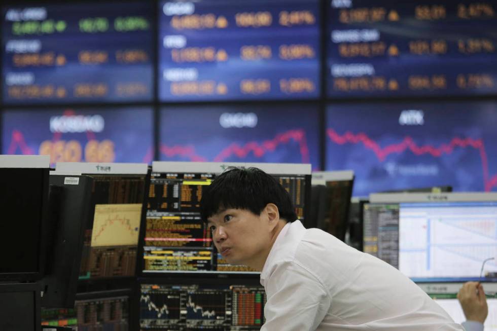 A currency trader watches monitors at the foreign exchange dealing room of the KEB Hana Bank he ...