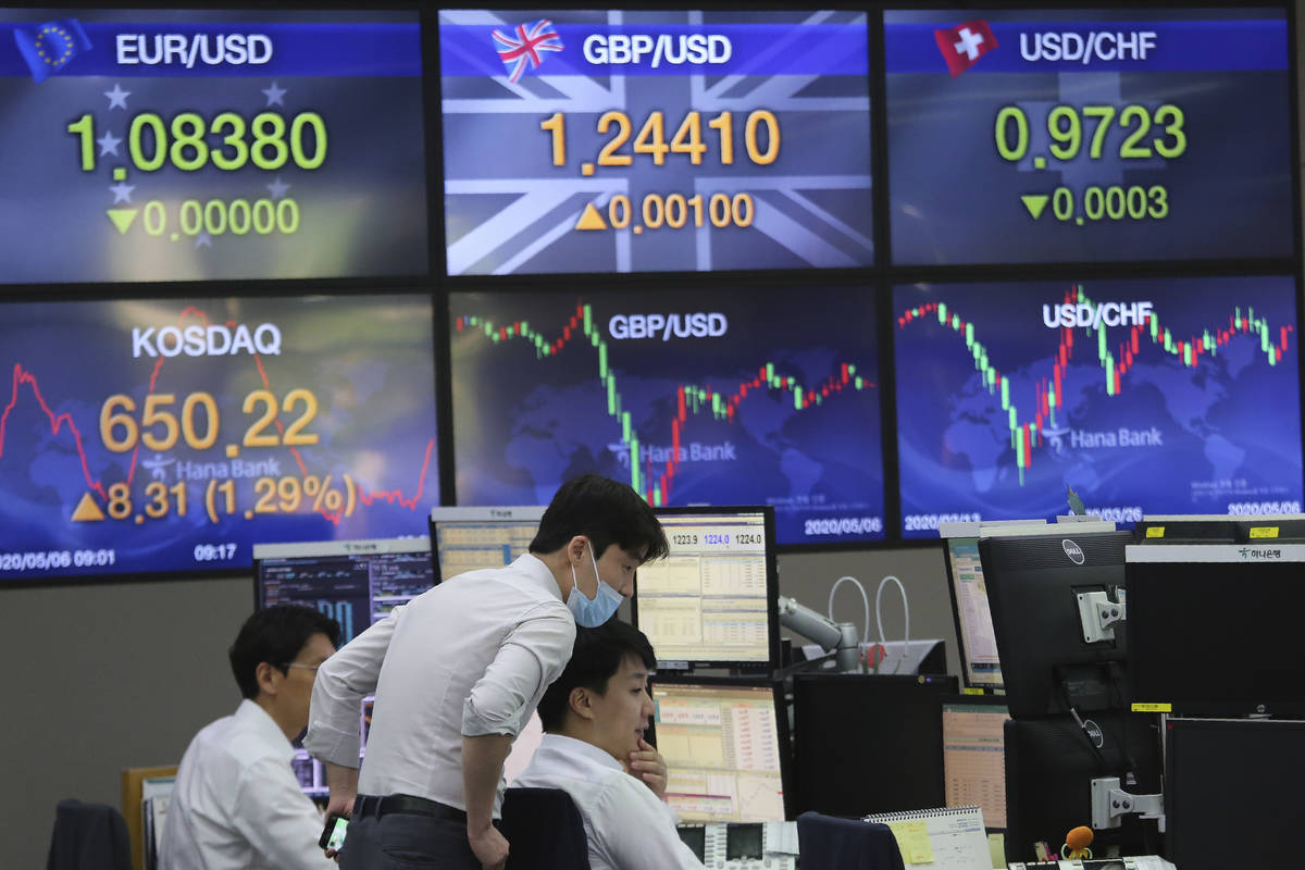 Currency traders watch monitors at the foreign exchange dealing room of the KEB Hana Bank headq ...