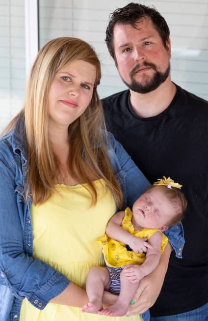 Christie Jensen, her boyfriend Jesse Zavala and their 1-month-old baby Eliana Zavala pose for a ...